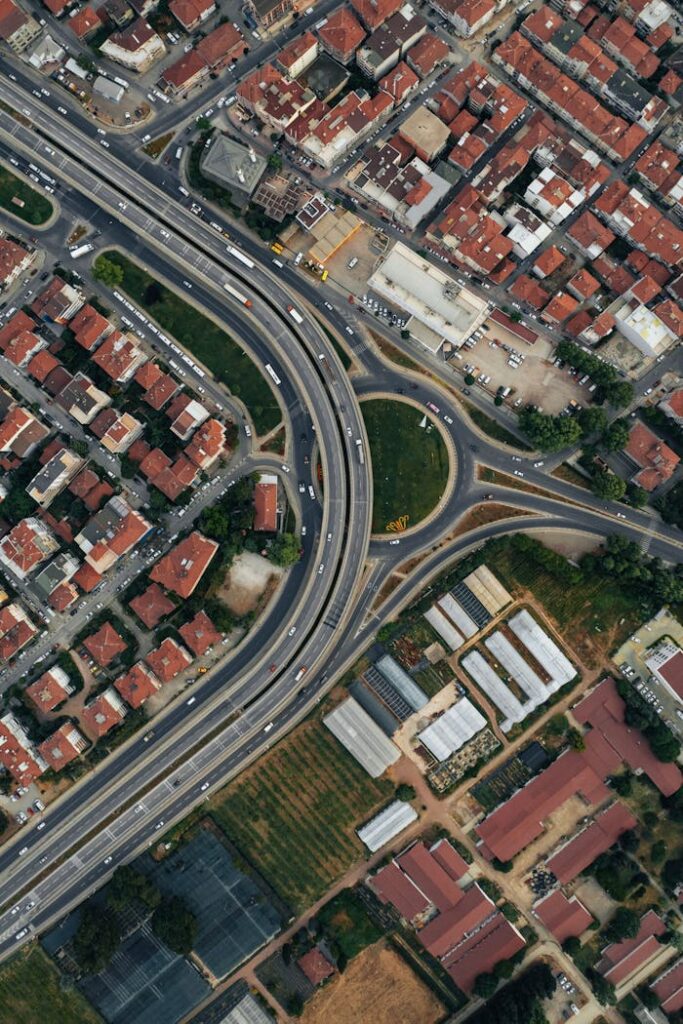 A detailed aerial photograph showcasing a city's highway and suburban housing layout, ideal for urban planning themes.